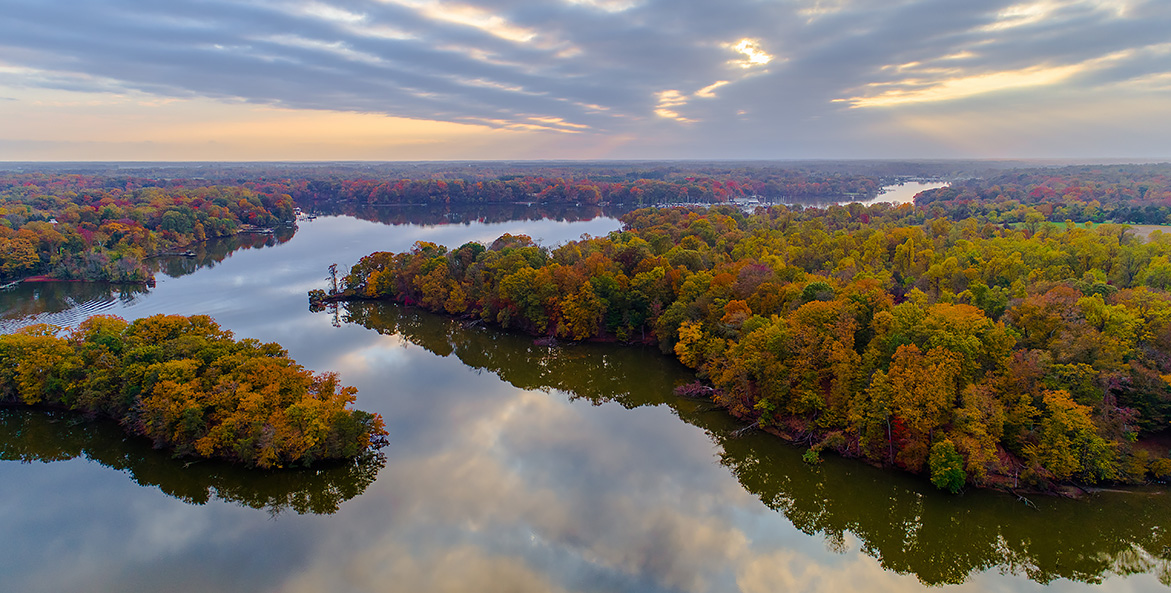 An aerial view of forests flanking a river.